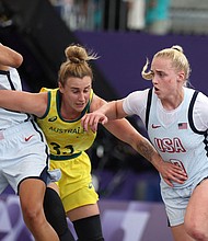 Van Lith and Burdick in action against Lauren Mansfield of Australia.
Mandatory Credit:	Pilar Olivares/Reuters via CNN Newsource