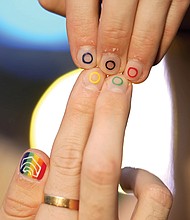 Jeremy Goupille shows his nails painted with the rainbow colors and the Olympic rings at the opening of Pride House, the safe space for the LGBT+ community of athletes, during the 2024 Summer Olympics.