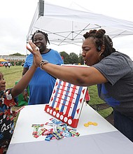 Edward Butler III, left, shows his enthusiasm with Salena Scott, right, a teacher at Martin Luther King Jr. Middle School, as Nicole Sparkman, a teacher at Armstrong High School looks on.