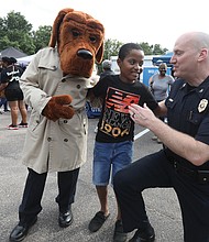 McGruff the Crime Dog, 11-year-old Anthony Johnson, and Richmond Police Chief Rick Edwards share a cheerful moment during the annual National Night Out event. The community gathering took place Tuesday, Aug. 6, at Hobson Lodge on Richmond’s South Side.