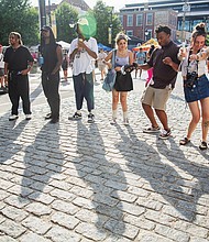 Revelers listen to live music during 804 Day in Shockoe Bottom.