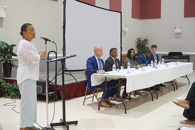 From left, Antoinette Essa speaks and candidates Andreas Addison, Danny Avula, Michelle Mosby, Maurice Neblett and Harrison Roday look on during the Richmond Crusade for Voters’ mayoral forum last Thursday at Third Street Bethel AME Church.