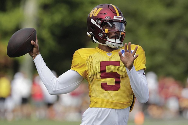 Washington Commanders quarterback Jayden Daniels throws the ball Aug. 4 during a football practice at the team’s training facility in Ashburn, Va