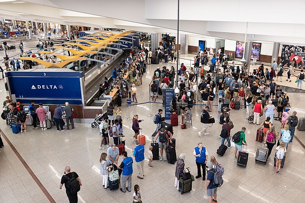 Delta Airlines passengers line up for agent assistance at Hartsfield-Jackson Atlanta International Airport on July 22, 2024.
Mandatory Credit:	Jessica McGowan/Getty Images via CNN Newsource