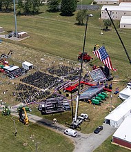 A drone view shows the stage where former President Donald Trump had been standing during an assassination attempt the day before, and the roof of a nearby building where a gunman was shot dead by law enforcement, in Butler, Pennsylvania, on July 14.
Mandatory Credit:	Carlos Osorio/Reuters via CNN Newsource