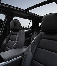 Rear-facing view of the next-generation 2025 GMC Terrain Elevation’s new interior, showing the driver and front passenger seats.