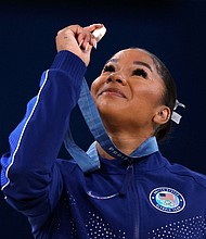 American gymnast Jordan Chiles looks at her bronze medal after the floor event on August 5.
Mandatory Credit:	Amanda Perobelli/Reuters via CNN Newsource