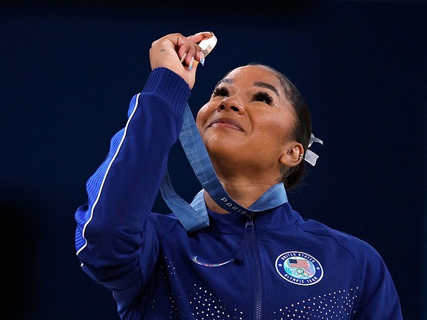 American gymnast Jordan Chiles looks at her bronze medal after the floor event on August 5.
Mandatory Credit:	Amanda Perobelli/Reuters via CNN Newsource