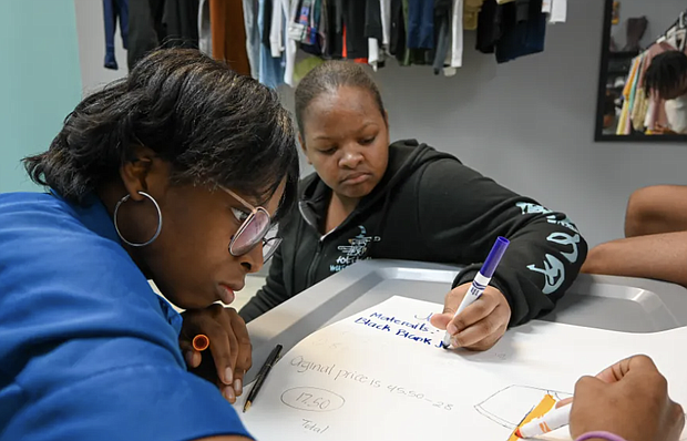 During summer programming, students participate in an exercise that requires their group to practice developing an original business idea and financial plan