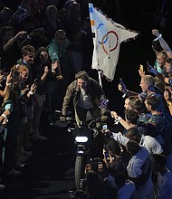 Tom Cruise rode a motorbike with the Olympic flag on the back of it during the 2024 Olympics closing ceremony.
Mandatory Credit:	Dita Alangkara/AP via CNN Newsource
