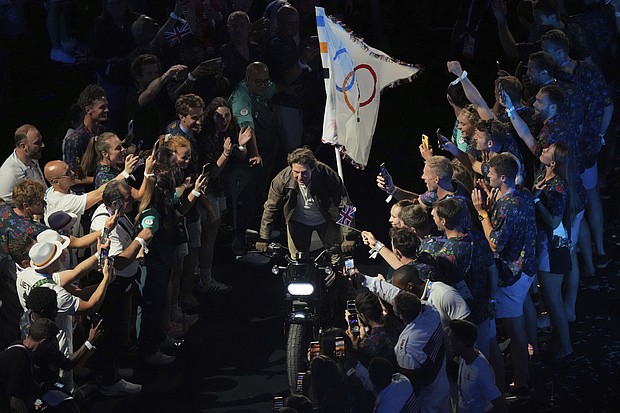 Tom Cruise rode a motorbike with the Olympic flag on the back of it during the 2024 Olympics closing ceremony.
Mandatory Credit:	Dita Alangkara/AP via CNN Newsource