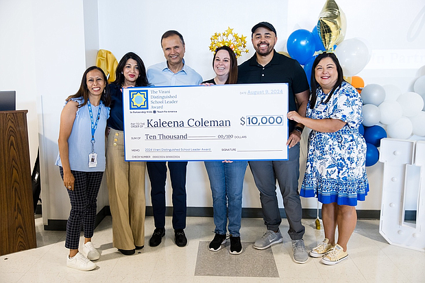 Dr. Asha and Farid Virani present the award check to Kaleena Coleman, one of the two 2024 Virani Distinguished School Leader Award winners.

From left to right: Sehba Ali (CEO, KIPP Texas), Dr. Asha and Farid Virani (Founders, Virani Distinguished School Leader Award), Kaleena Coleman (Winner, Virani Distinguished School Leader Award), Rodney Coleman Jr. (Kaleena’s husband), and Tiffany Cuellar Needham (Executive Director, TFA Houston).