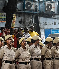 Police officers stand outside the emergency ward during a doctors' strike to protest the rape and murder of a medic at RG Kar Medical College and Hospital in Kolkata, India, on August 11.
Mandatory Credit:	Sudipta Das/NURPHO/AP via CNN Newsource