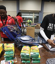 CoStar Group colleagues Keenan Winston, left, and Neri Stephenson team up with hundreds of volunteers to pack over 39,000 backpacks for Richmond Public Schools students during the seventh annual Ultimate Backpack Supply Drive on Aug. 8 at the Greater Richmond Convention Center.