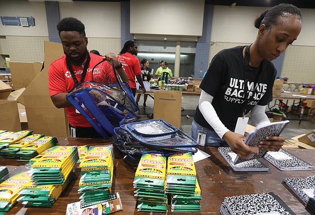 CoStar Group colleagues Keenan Winston, left, and Neri Stephenson team up with hundreds of volunteers to pack over 39,000 backpacks for Richmond Public Schools students during the seventh annual Ultimate Backpack Supply Drive on Aug. 8 at the Greater Richmond Convention Center.