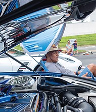 Barry Wilkerson watches the wheels go by next to his 2016 Camaro. The Department of
Motor Vehicles marked its 100th anniversary with a “Through the Decades: DMV Classic Car
Show” on Aug. 3.
