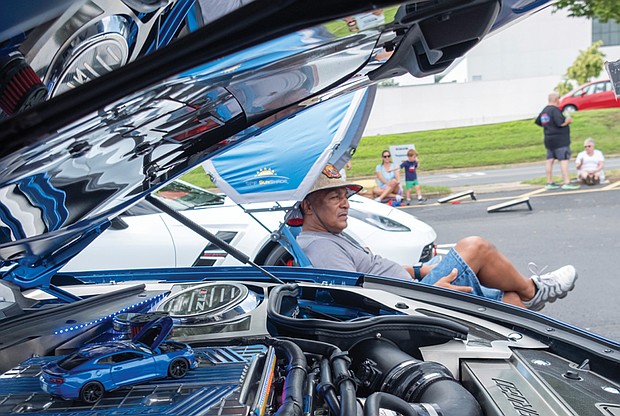 Barry Wilkerson watches the wheels go by next to his 2016 Camaro. The Department of
Motor Vehicles marked its 100th anniversary with a “Through the Decades: DMV Classic Car
Show” on Aug. 3.