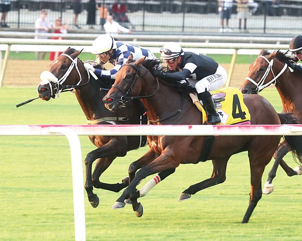 Jockey Jose Ortiz rides thoroughbred Moira to a close victory over Fev Rover and jockey Javier Castellano during the Beverly D race at Colonial Downs’ Festival of Racing on Aug. 11.