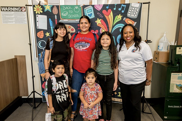 Harris County Clerk Teneshia Hudspeth with the Hernandez family at the Back-toSchool Birth Certificate Event at the Pasadena Annex, Saturday, July 29, 2023.