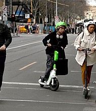 People ride e-scooters in Melbourne's central business district on August 14, as Melbourne has become the latest city to announce a ban on rental e-scooters.
Mandatory Credit:	William West/AFP/Getty Images via CNN Newsource