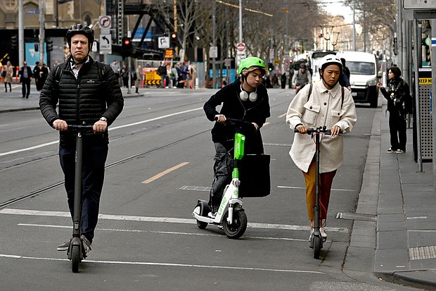 People ride e-scooters in Melbourne's central business district on August 14, as Melbourne has become the latest city to announce a ban on rental e-scooters.
Mandatory Credit:	William West/AFP/Getty Images via CNN Newsource