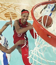 Aja Wilson shoots as Marieme Badiane looks to block Aug. 11, during a women’s gold medal basketball game between the United States and France at the 2024 Summer Olympics in Paris.
