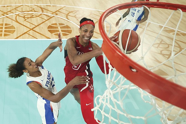 Aja Wilson shoots as Marieme Badiane looks to block Aug. 11, during a women’s gold medal basketball game between the United States and France at the 2024 Summer Olympics in Paris.