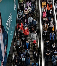 Xiaotu paid for a personal advertisement on a electronic billboard at a local subway to find his soulmate, and pictured are commuters 
heading to the subway platform during rush hour in Beijing in 2020.
Mandatory Credit:	Kevin Frayer/Getty Images via CNN Newsource