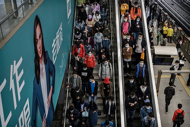 Xiaotu paid for a personal advertisement on a electronic billboard at a local subway to find his soulmate, and pictured are commuters 
heading to the subway platform during rush hour in Beijing in 2020.
Mandatory Credit:	Kevin Frayer/Getty Images via CNN Newsource