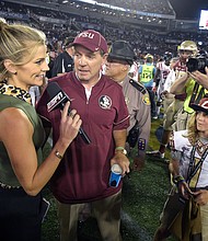 Samantha Ponder, pictured interviewing then-Florida State head coach Jimbo Fisher after a game in 2016, has been fired by ESPN.
Mandatory Credit:	Phelan M. Ebenhack/AP via CNN Newsource