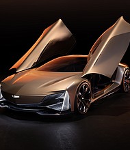 Front 3/4 view of Cadillac Opulent Velocity concept vehicle with open butterfly doors.