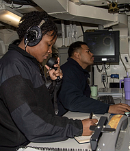 Quartermaster 2nd class Elizabeth Sylvester, left, a native of Baytown, Texas, and Quartermaster 2nd Class RC Onopey, a native of Guam/
Photo by Seaman Apprentice Rocio Zavala-Ramirez