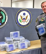 Collier County Sheriff Kevin Rambosk posing with drugs found floating in the Gulf of Mexico near Everglades City
Mandatory Credit:	Collier County Sheriff's Office via CNN Newsource
