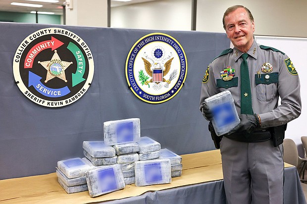 Collier County Sheriff Kevin Rambosk posing with drugs found floating in the Gulf of Mexico near Everglades City
Mandatory Credit:	Collier County Sheriff's Office via CNN Newsource