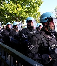 Police line up after a piece of fence was knocked down by protesters surrounding the United Center at the Democratic National Convention Monday, Aug. 19, 2024, in Chicago.
Mandatory Credit:	Alex Brandon/AP via CNN Newsource