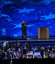Former President Barack Obama and Michelle Obama embrace on stage on August 20, during the DNC in Chicago.
Mandatory Credit:	Bernadette Tuazon/CNN via CNN Newsource