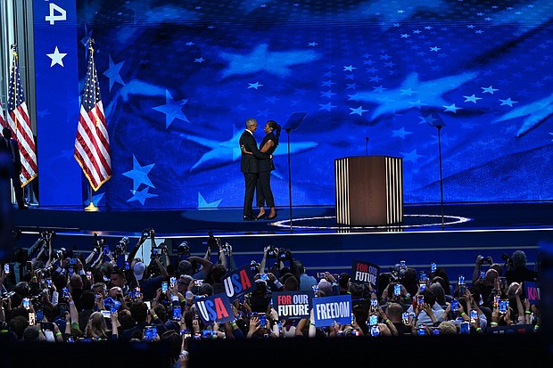 Former President Barack Obama and Michelle Obama embrace on stage on August 20, during the DNC in Chicago.
Mandatory Credit:	Bernadette Tuazon/CNN via CNN Newsource
