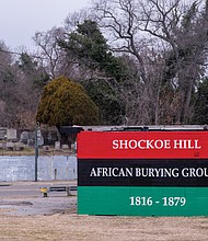 A mural covers an abandoned gas station that sits on top of graves in the Shockoe Hill African Burying Ground at 1305 N. 5th St.