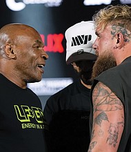 Mike Tyson, left, and Jake Paul face off during a May 16 news conference promoting their upcoming boxing bout, now scheduled for Nov. 15.