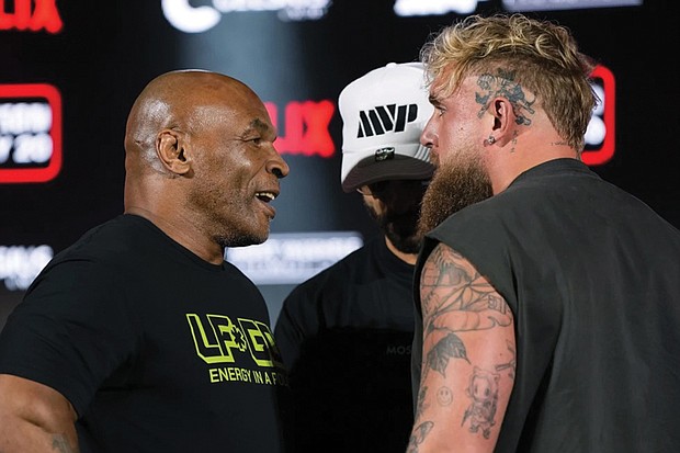 Mike Tyson, left, and Jake Paul face off during a May 16 news conference promoting their upcoming boxing bout, now scheduled for Nov. 15.