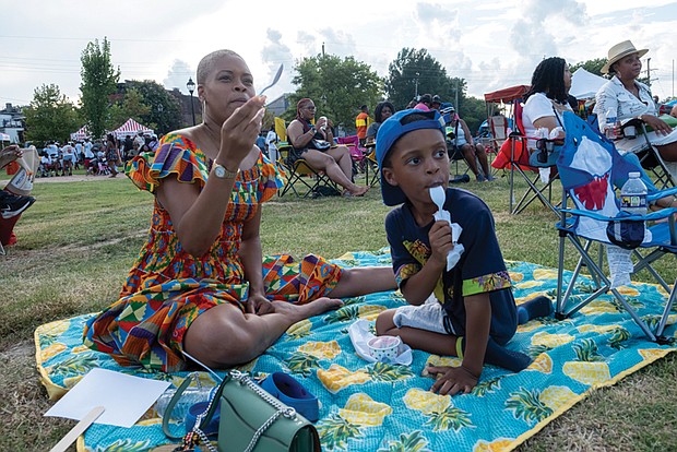 Soliel Lindsey and her 5-year-old son, Samaad Lindsey-Jones, enjoy ice cream at Abner Clay Park in Jackson Ward during the 33rd Down Home Family Reunion on Aug. 17.