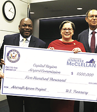Congresswoman Jennifer McClellan presents a $500,000 check to Charles S. Macfarlane, Perry Miller and James M. Holland of the Capital Region Airport Commission on Aug. 26 at Richmond International Airport.