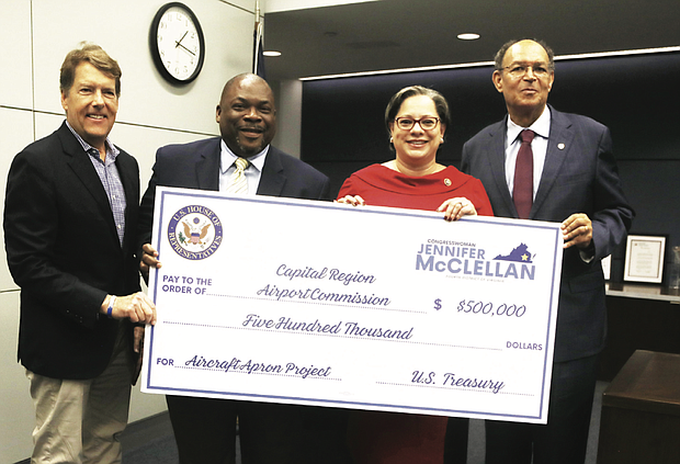 Congresswoman Jennifer McClellan presents a $500,000 check to Charles S. Macfarlane, Perry Miller and James M. Holland of the Capital Region Airport Commission on Aug. 26 at Richmond International Airport.