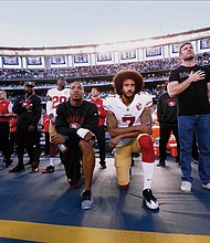 Eric Reid and Colin Kaepernick kneel during the national anthem, San Diego, Sept. 1, 2016.