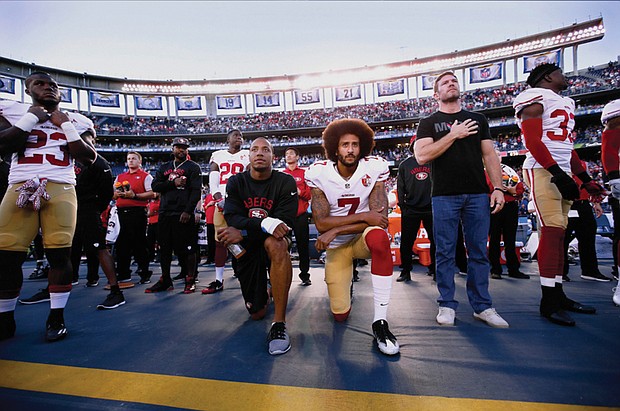 Eric Reid and Colin Kaepernick kneel during the national anthem, San Diego, Sept. 1, 2016.