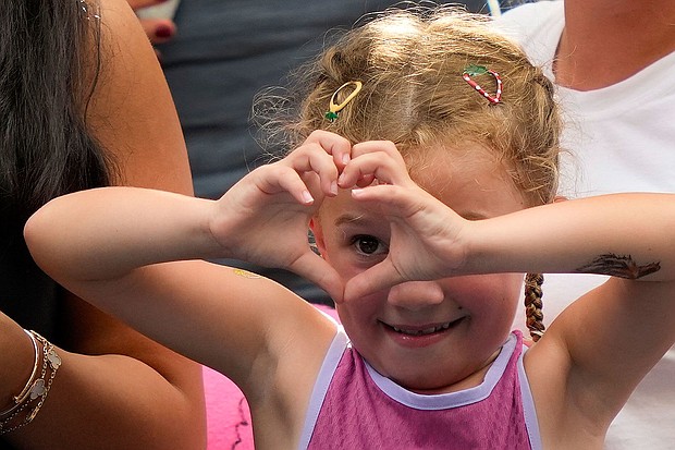 The young tennis fan motions to Sabalenka after the match.
Mandatory Credit:	Julia Nikhinson/AP via CNN Newsource