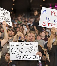 People hold signs for a "yes" vote as members and supporters of the International Association of Machinists attend an early strike-sanction vote event at T-Mobile Park in Seattle, Washington on July 17. The union is set to strike Boeing for the first time in 16 years on September 13 without a deal on a new contract.
Mandatory Credit:	Jason Redmond/AFP/Getty Images via CNN Newsource