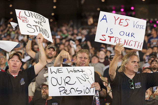 People hold signs for a "yes" vote as members and supporters of the International Association of Machinists attend an early strike-sanction vote event at T-Mobile Park in Seattle, Washington on July 17. The union is set to strike Boeing for the first time in 16 years on September 13 without a deal on a new contract.
Mandatory Credit:	Jason Redmond/AFP/Getty Images via CNN Newsource