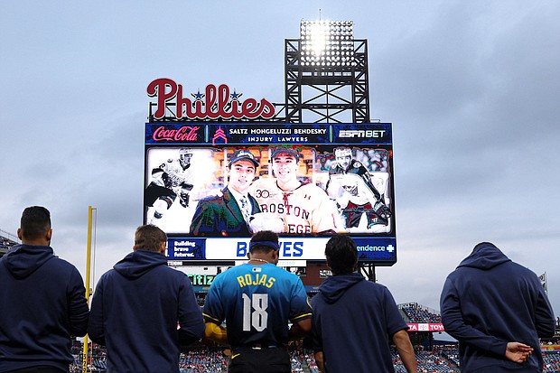 Players and fans stand for a moment of silence for NHL player Johnny Gaudreau who passed away the night before the game between the Philadelphia Phillies and the Atlanta Braves at Citizens Bank Park in Philadelphia, Pennsylvania, on Friday, August 30.
Mandatory Credit:	Bill Streicher/USA Today Sports/Reuters via CNN Newsource