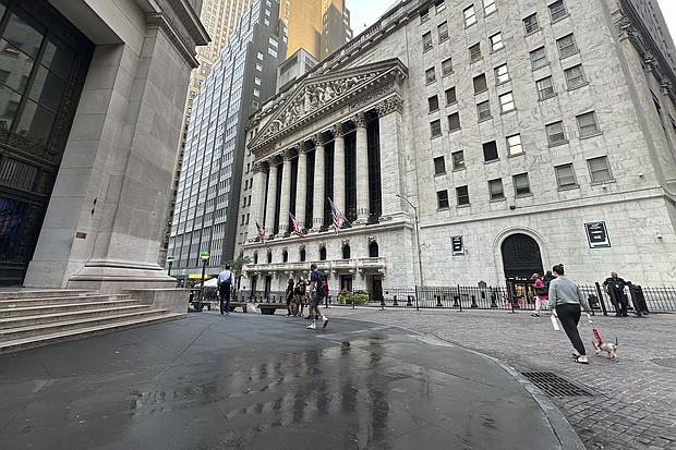 People pass the New York Stock Exchange on August 28.
Mandatory Credit:	Peter Morgan/AP via CNN Newsource